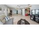 Spacious living room features tile flooring, ceiling fan and access to other areas of the home at 7231 Elyton Dr, North Port, FL 34287
