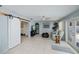 Bright living room with tile flooring, barn door detail, ceiling fan, and comfortable seating at 7231 Elyton Dr, North Port, FL 34287