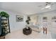 Cozy living room with a ceiling fan, tile floors and backyard views at 7231 Elyton Dr, North Port, FL 34287
