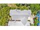 Aerial view of a home with a metal roof, surrounded by lush greenery and trees at 936 Hemingway Cir, Tampa, FL 33602