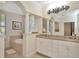 Luxurious bathroom with a soaking tub, dual sinks, granite countertops, and decorative lighting at 936 Hemingway Cir, Tampa, FL 33602
