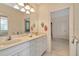 Bathroom showcasing a dual sink vanity, white cabinetry, and a view into other rooms at 936 Hemingway Cir, Tampa, FL 33602