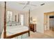 Bright bedroom featuring a four-poster bed, ceiling fan, and access to an outdoor patio at 936 Hemingway Cir, Tampa, FL 33602
