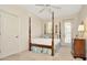 Well-lit bedroom with a four-poster bed, neutral walls, and a ceiling fan at 936 Hemingway Cir, Tampa, FL 33602