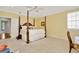This bedroom features a ceiling fan and a large four-poster bed, offering a blend of comfort and classic design at 936 Hemingway Cir, Tampa, FL 33602