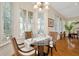Bright dining area featuring a glass table, hardwood floors, and natural light through shuttered windows at 936 Hemingway Cir, Tampa, FL 33602