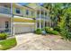 Charming two-story home with a bright yellow exterior and a welcoming front porch at 936 Hemingway Cir, Tampa, FL 33602