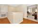 Hallway with hardwood floors leads to a bedroom with a study, providing a bright and airy space at 936 Hemingway Cir, Tampa, FL 33602