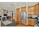 Spacious kitchen featuring wood cabinets, stainless steel appliances, and an island sink at 936 Hemingway Cir, Tampa, FL 33602