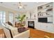 Inviting living room features a cozy fireplace with built-in shelving and abundant natural light at 936 Hemingway Cir, Tampa, FL 33602