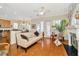 Sun-drenched living room boasts a fireplace, hardwood floors, and easy access to the kitchen at 936 Hemingway Cir, Tampa, FL 33602