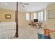 Bedroom featuring bay window seating area with natural light and four-poster bed with ceiling fan at 936 Hemingway Cir, Tampa, FL 33602