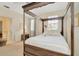 Comfortable main bedroom features a four-poster bed and soothing natural light at 936 Hemingway Cir, Tampa, FL 33602