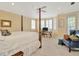 Spacious bedroom with sitting area, bay windows, ceiling fan, and four-poster bed frame at 936 Hemingway Cir, Tampa, FL 33602