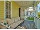 Relaxing porch featuring a neutral-colored sectional sofa and a distant view of other homes at 936 Hemingway Cir, Tampa, FL 33602