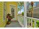 A welcoming entryway with a beautiful pot of plants and a view of tropical landscaping at 936 Hemingway Cir, Tampa, FL 33602