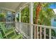 Covered porch with two green rocking chairs surrounded by lush tropical foliage at 936 Hemingway Cir, Tampa, FL 33602