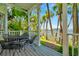 Charming porch with seating overlooks lush greenery, offering a serene outdoor retreat at 936 Hemingway Cir, Tampa, FL 33602