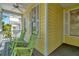 A charming porch area with wicker rocking chairs on a yellow home at 936 Hemingway Cir, Tampa, FL 33602