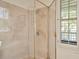 Bright bathroom featuring a stand-up tiled shower with clear glass doors and gold trim at 936 Hemingway Cir, Tampa, FL 33602