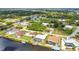 A beautiful aerial view of waterfront homes featuring mature trees and tranquil canal access in a residential area at 9582 Arsipe Cir, Port Charlotte, FL 33981