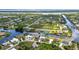 An elevated shot of canal-front houses surrounded by established greenery in a residential community at 9582 Arsipe Cir, Port Charlotte, FL 33981