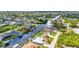 Overhead view of homes along a waterfront canal, with lush greenery and neighborhood layout at 9582 Arsipe Cir, Port Charlotte, FL 33981