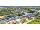 Aerial view of a residential area with waterfront homes, lush landscaping, and private docks at 9582 Arsipe Cir, Port Charlotte, FL 33981