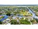 Bird's eye view of homes on tranquil canals, amid lush surroundings in a residential locale at 9582 Arsipe Cir, Port Charlotte, FL 33981