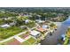 A scenic aerial view displaying homes near canals, accented by mature trees in a residential community at 9582 Arsipe Cir, Port Charlotte, FL 33981