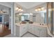 Spacious bathroom with dual sinks and glass-enclosed shower with glass block window at 9582 Arsipe Cir, Port Charlotte, FL 33981