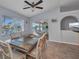 Inviting dining area with waterfront views, a ceiling fan, and a stylish table setting for elegant dining at 9582 Arsipe Cir, Port Charlotte, FL 33981