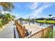 Waterfront dock overlooking canal with boat dock and homes in the background at 9582 Arsipe Cir, Port Charlotte, FL 33981