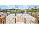 Waterfront dock with wood planks and railings overlooking canal and homes at 9582 Arsipe Cir, Port Charlotte, FL 33981