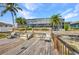 Multi-level wooden dock and entertainment area with seating overlooking the canal at 9582 Arsipe Cir, Port Charlotte, FL 33981