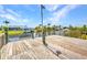 Wooden waterfront dock featuring boat docks and landscaping at 9582 Arsipe Cir, Port Charlotte, FL 33981