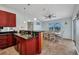 The kitchen and dining area features dark granite countertops and matching cabinetry at 9582 Arsipe Cir, Port Charlotte, FL 33981