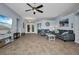 Spacious living room with tiled floors, comfortable seating, and easy access to other areas of the home at 9582 Arsipe Cir, Port Charlotte, FL 33981