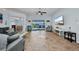 Bright living room with tiled floors, a ceiling fan, and views of the pool area through sliding glass doors at 9582 Arsipe Cir, Port Charlotte, FL 33981