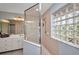 The updated shower provides natural light through a unique glass block window at 9582 Arsipe Cir, Port Charlotte, FL 33981