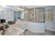 Well-lit bathroom featuring glass block window and a glass enclosed shower at 9582 Arsipe Cir, Port Charlotte, FL 33981