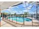 Screened-in pool area with a beautiful view of the canal and neighborhood at 9582 Arsipe Cir, Port Charlotte, FL 33981