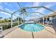 Clear view of the screened-in pool and outdoor area with a beautiful blue sky at 9582 Arsipe Cir, Port Charlotte, FL 33981