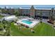 Aerial view of the community pool and condos overlooking the Gulf, perfect for waterfront living at 101 N Marion Ct # 133, Punta Gorda, FL 33950