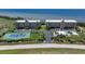 Aerial view of condos with tennis court, pool, and stunning water views, perfect for resort living at 101 N Marion Ct # 133, Punta Gorda, FL 33950