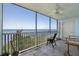 Screened balcony featuring tiled floors, ceiling fan, and stunning ocean views with comfortable chair seating at 101 N Marion Ct # 133, Punta Gorda, FL 33950