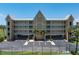 Three-story condo building featuring beautiful balconies, covered parking, and lush palm tree landscaping at 101 N Marion Ct # 133, Punta Gorda, FL 33950