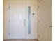 Elegant white front door featuring digital lock and sidelight window plus adjacent door, providing convenient access at 101 N Marion Ct # 133, Punta Gorda, FL 33950
