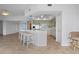 Modern kitchen with barstool seating, stainless steel appliances, light green cabinetry, and open access to living area at 101 N Marion Ct # 133, Punta Gorda, FL 33950