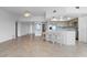 Open concept living with tile flooring, breakfast bar, and kitchen with stainless steel appliances at 101 N Marion Ct # 133, Punta Gorda, FL 33950